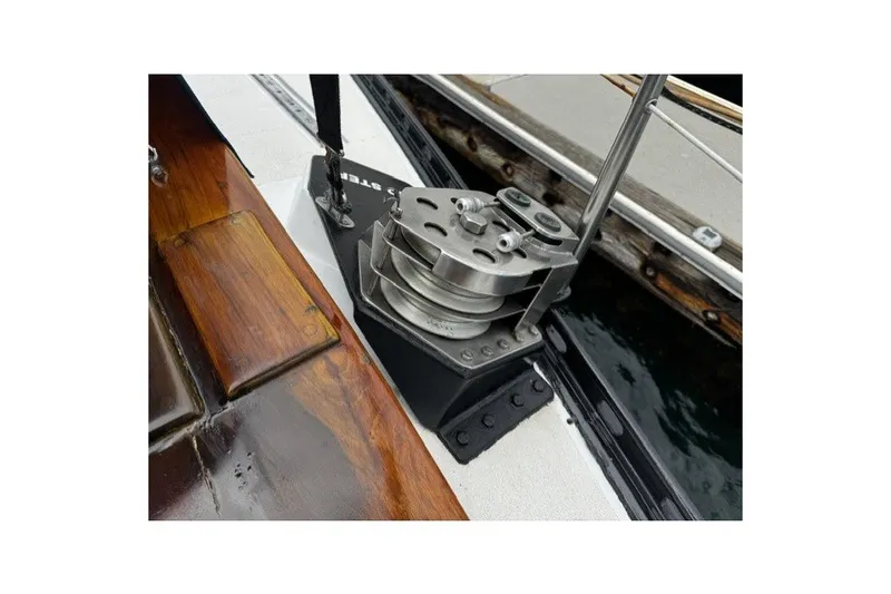 Slide: The Image of Winch mechanism on a 1973 C&C 48 sailboat, featuring polished metal and wooden deck elements. - 31