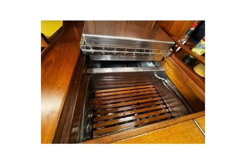Slide: The Image of Wooden interior of a 1973 C&C 48 yacht with a metal stove and grill. - 21