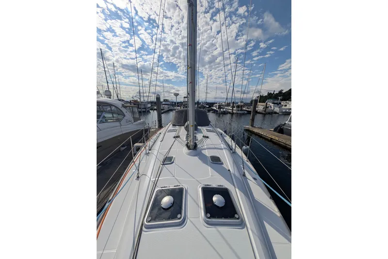 Slide: The Image of 2006 Jeanneau Sun Odyssey 45 sailboat docked at marina under partly cloudy sky. - 14