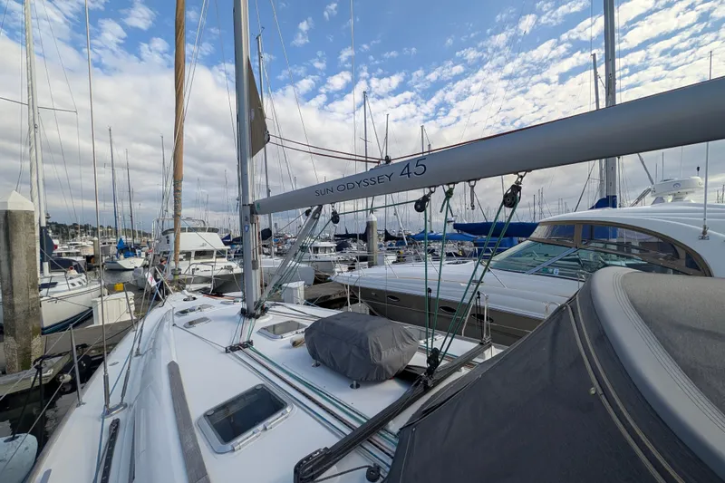 Slide: The Image of 2006 Jeanneau Sun Odyssey 45 sailboat docked in a marina under a partly cloudy sky. - 11