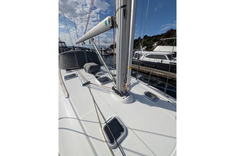 Slide: The Image of 2006 Jeanneau Sun Odyssey 45 sailboat deck with mast, docked at marina under blue sky. - 15