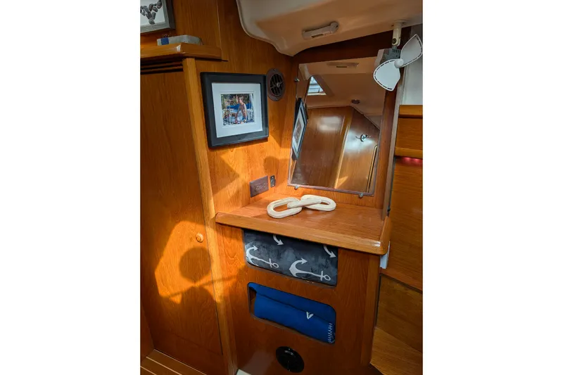 Slide: The Image of Interior of 2006 Jeanneau Sun Odyssey 45 yacht with wooden cabinetry and nautical decor. - 40