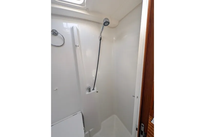 Slide: The Image of Shower area in 2006 Jeanneau Sun Odyssey 45 yacht, featuring sleek white interior design. - 44