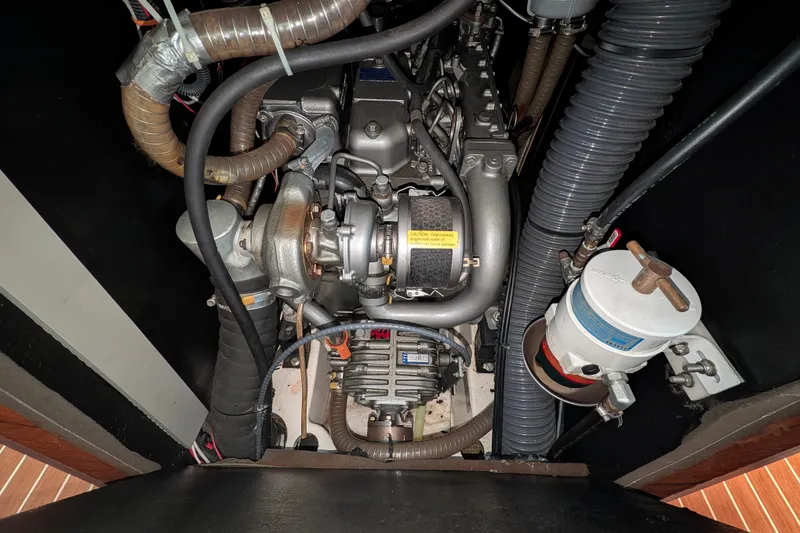Slide: The Image of Engine compartment of a 2006 Jeanneau Sun Odyssey 45 sailboat, showcasing mechanical components. - 47