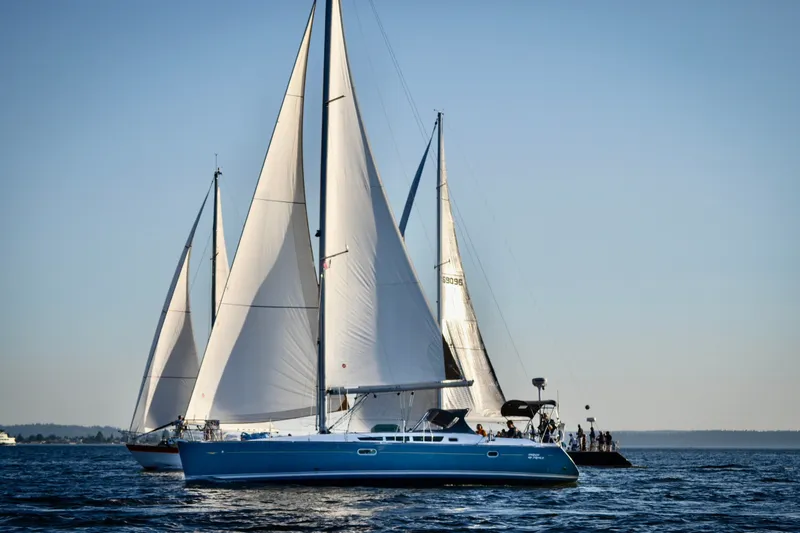 Slide: The Image of Sailboats on open water, featuring a 2006 Jeanneau Sun Odyssey 45. - 49