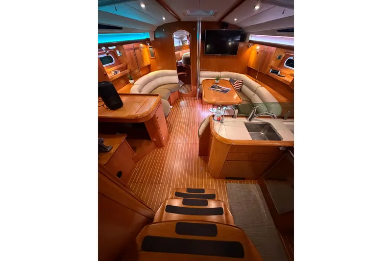 Slide: The Image of Interior of 2006 Jeanneau Sun Odyssey 45 yacht with elegant wood finish and cozy seating. - 22