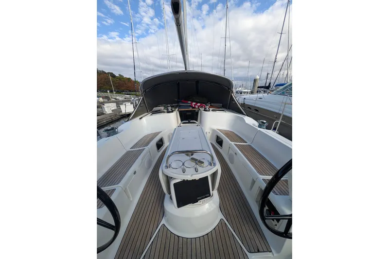 Slide: The Image of 2006 Jeanneau Sun Odyssey 45 sailboat cockpit with dual steering wheels and teak decking. - 8