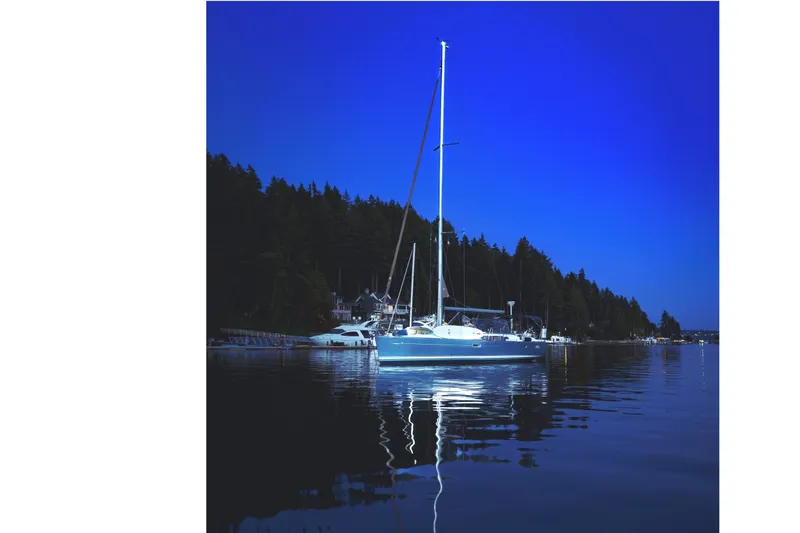 Slide: The Image of Sailboat Jeanneau Sun Odyssey 45, 2006, anchored at night with forest backdrop. - 4