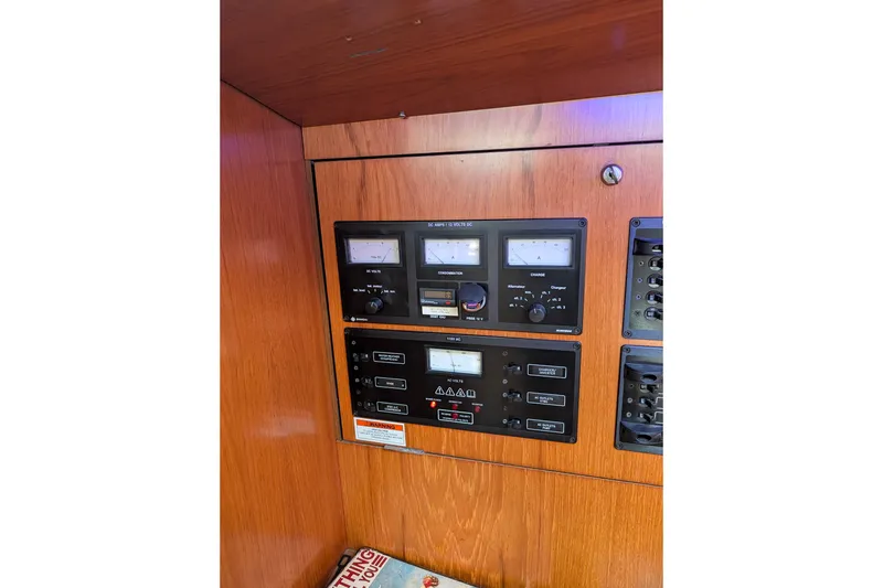 Slide: The Image of Electrical panel on a 2006 Jeanneau Sun Odyssey 45 sailboat, featuring gauges and controls. - 32