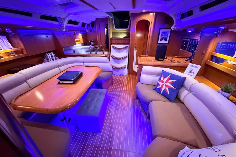 Slide: The Image of Luxurious interior of 2006 Jeanneau Sun Odyssey 45 yacht with elegant seating and ambient lighting. - 23