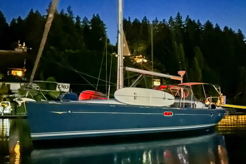 Slide: The Image of Jeanneau Sun Odyssey 45 sailboat, 2006 model, docked at night with forest backdrop. - 50