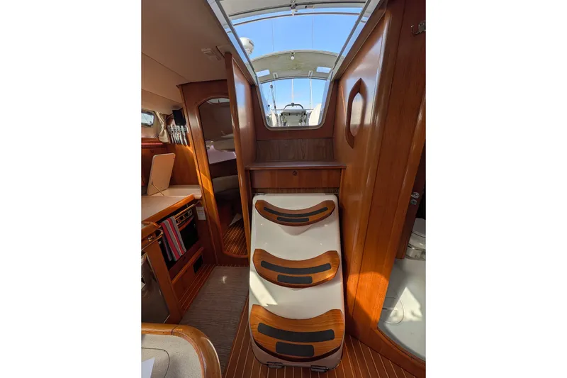 Slide: The Image of Interior of 2006 Jeanneau Sun Odyssey 45 sailboat with wooden stairs and cabin view. - 34