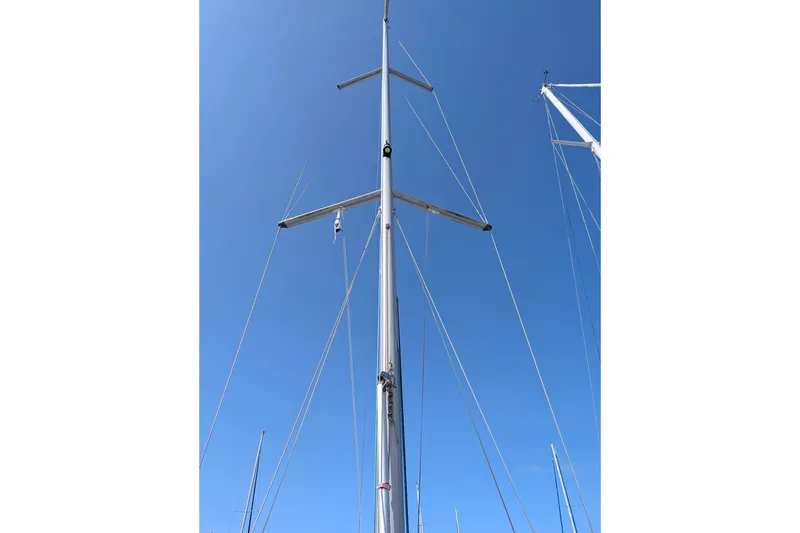 Slide: The Image of Mast of 2006 Jeanneau Sun Odyssey 45 sailboat against clear blue sky. - 20