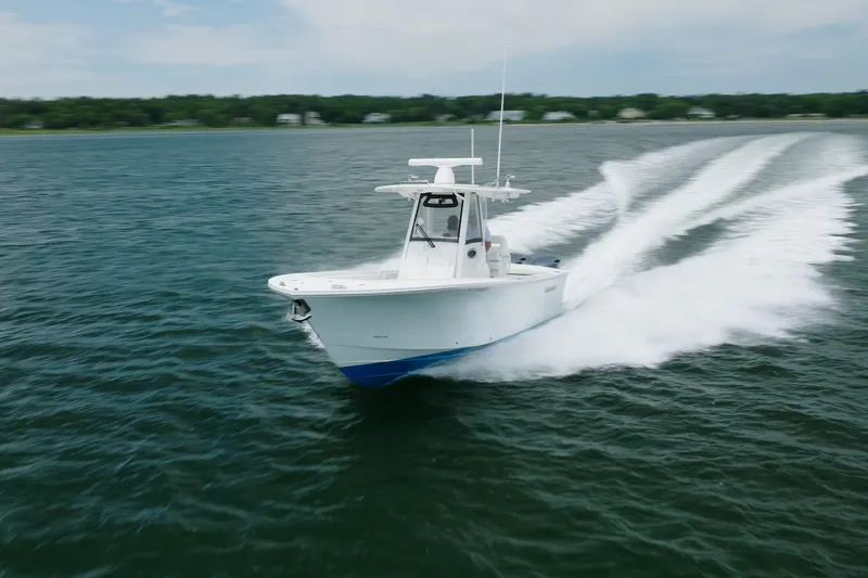 Slide: The Image of 2021 Regulator 28 Forward Seating boat cruising on open water. - 10