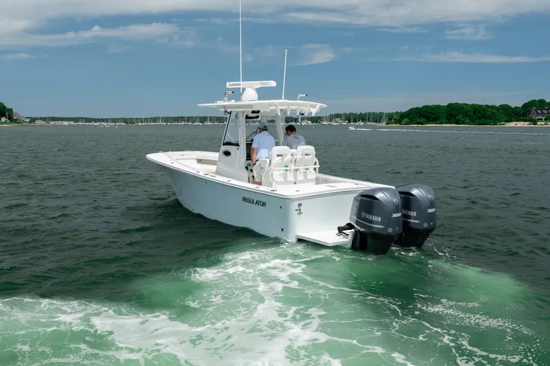 Slide: The Image of 2021 Regulator 28 Forward Seating boat cruising on a scenic waterway. - 9