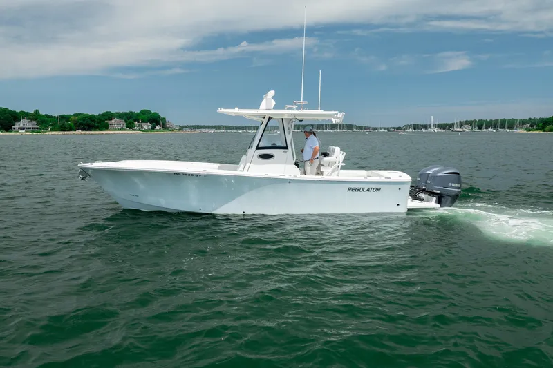 Slide: The Image of 2021 Regulator 28 Forward Seating boat cruising on a calm lake. - 4