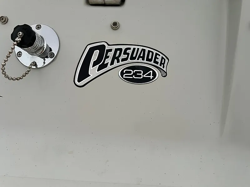 Slide: The Image of Close-up of the "Persuader 234" logo on a boat hull. - 1