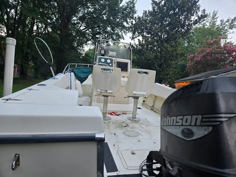 Slide: The Image of A 1999 Sea Pro 210 Center Console boat with two seats and a Johnson engine. - 3