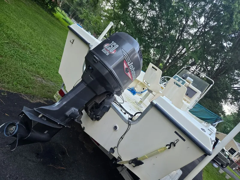Slide: The Image of A 1999 Sea Pro 210 Center Console boat with an outboard motor, parked on a driveway. - 5