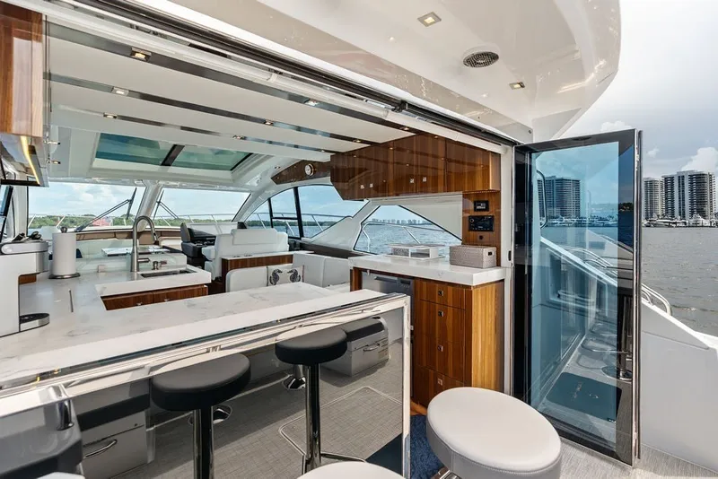 Slide: The Image of Luxurious interior of 2022 Cruisers Yachts 54 Cantius with modern kitchen and seating area. - 37
