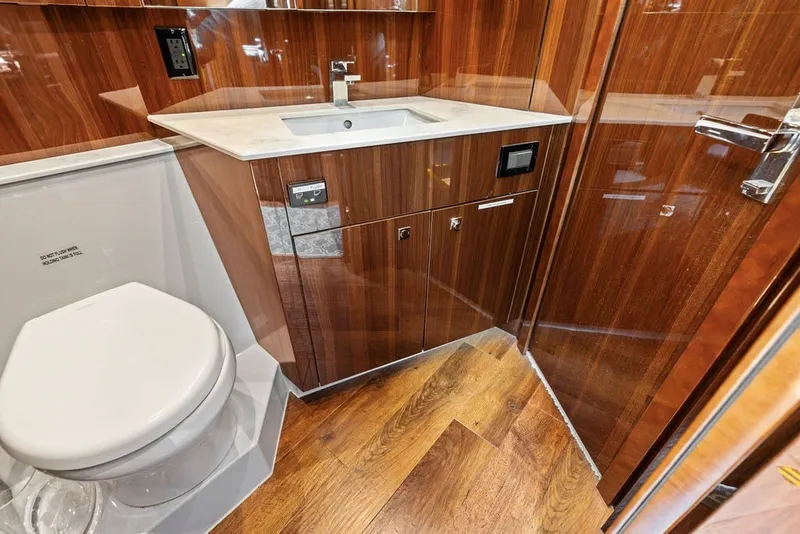 Slide: The Image of Luxurious bathroom interior of 2022 Cruisers Yachts 54 Cantius with wood finish and modern fixtures. - 67