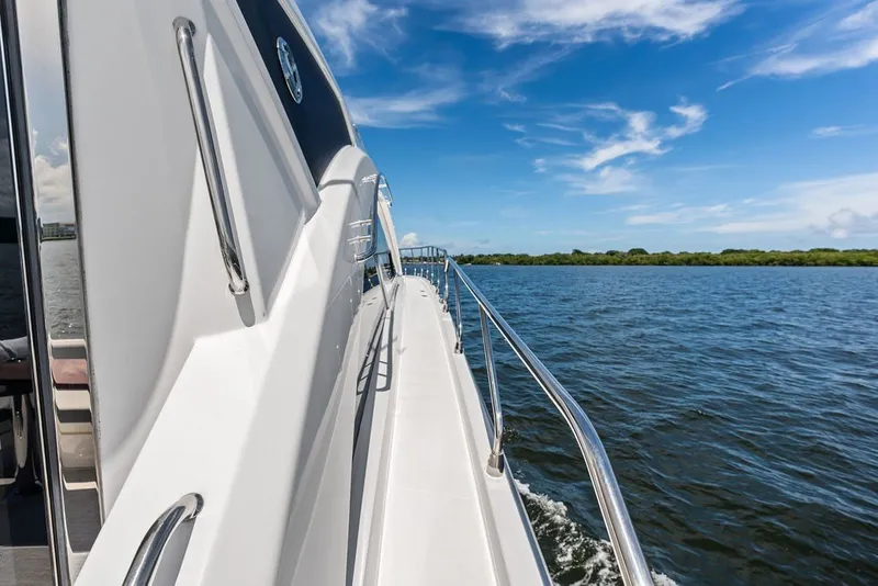 Slide: The Image of 2022 Cruisers Yachts 54 Cantius cruising on a sunny day, blue sky and water. - 26