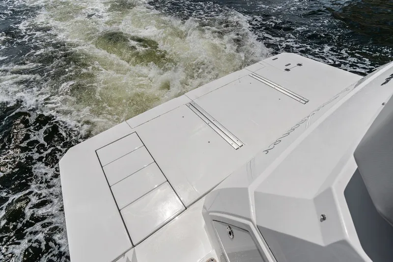Slide: The Image of 2022 Cruisers Yachts 54 Cantius, rear deck view with water wake. - 29
