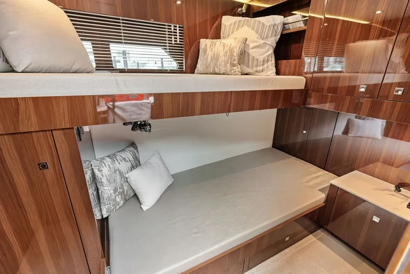 Slide: The Image of Luxurious 2022 Cruisers Yachts 54 Cantius cabin with elegant wood finish and cozy bedding. - 69