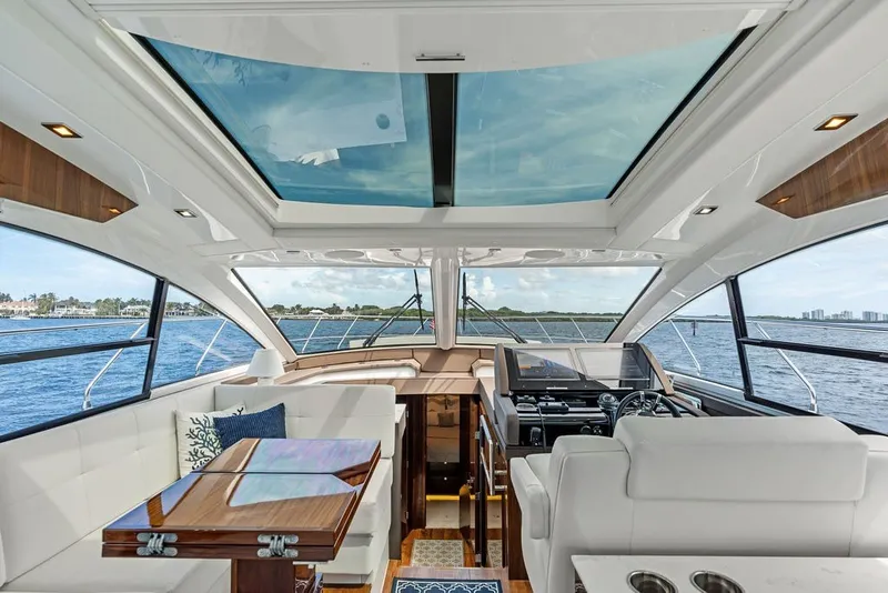 Slide: The Image of Luxurious interior of 2022 Cruisers Yachts 54 Cantius with panoramic windows and elegant seating. - 46