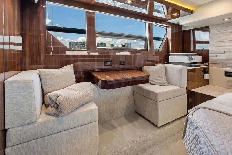Slide: The Image of Luxurious interior of 2022 Cruisers Yachts 54 Cantius with plush seating and elegant wood finishes. - 58