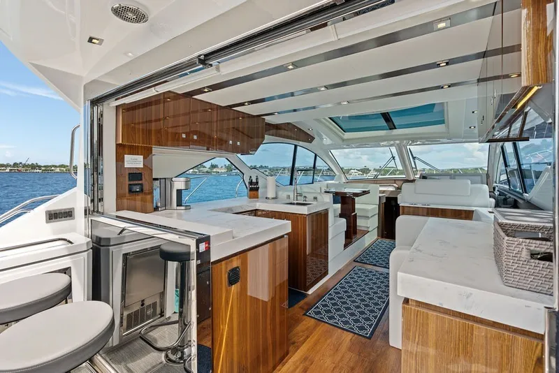 Slide: The Image of Luxurious interior of 2022 Cruisers Yachts 54 Cantius with modern kitchen and seating area. - 36
