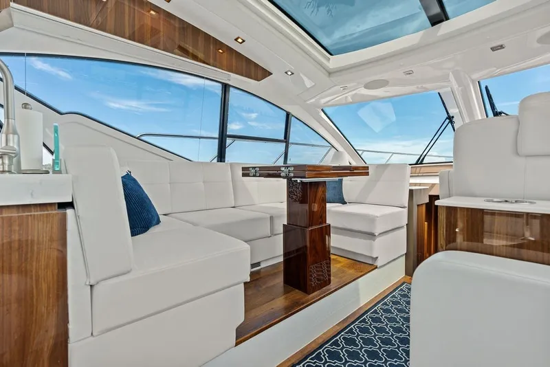 Slide: The Image of Luxurious interior of 2022 Cruisers Yachts 54 Cantius with elegant seating and panoramic windows. - 47