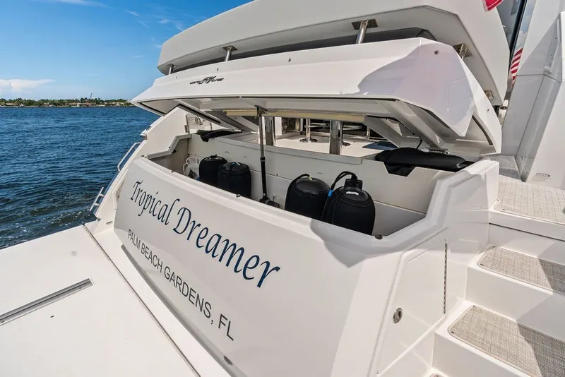 Slide: The Image of 2022 Cruisers Yachts 54 Cantius "Tropical Dreamer" docked, storage compartment open. - 27