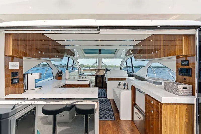 Slide: The Image of Luxurious interior of 2022 Cruisers Yachts 54 Cantius with modern kitchen and seating area. - 35