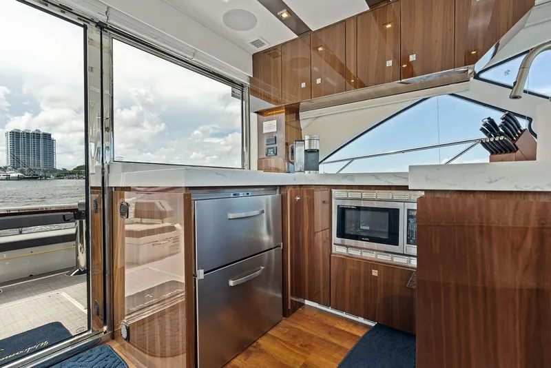 Slide: The Image of Luxurious 2022 Cruisers Yachts 54 Cantius kitchen with modern appliances and waterfront view. - 40