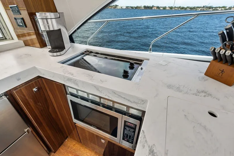 Slide: The Image of Luxurious kitchen area on 2022 Cruisers Yachts 54 Cantius with modern appliances and ocean view. - 41