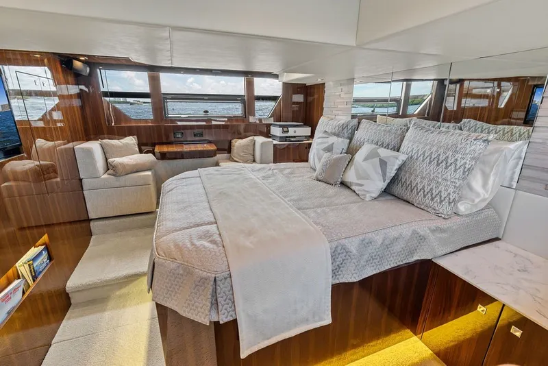 Slide: The Image of Luxurious interior of 2022 Cruisers Yachts 54 Cantius with elegant bedding and seating. - 56