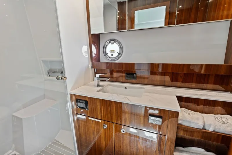 Slide: The Image of Luxurious bathroom interior of 2022 Cruisers Yachts 54 Cantius with wood accents and modern fixtures. - 62