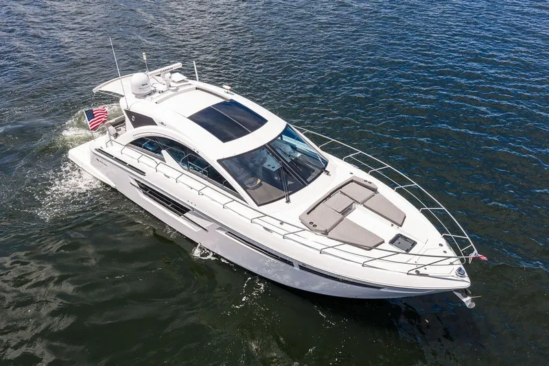 Slide: The Image of 2022 Cruisers Yachts 54 Cantius luxury boat cruising on open water. - 15