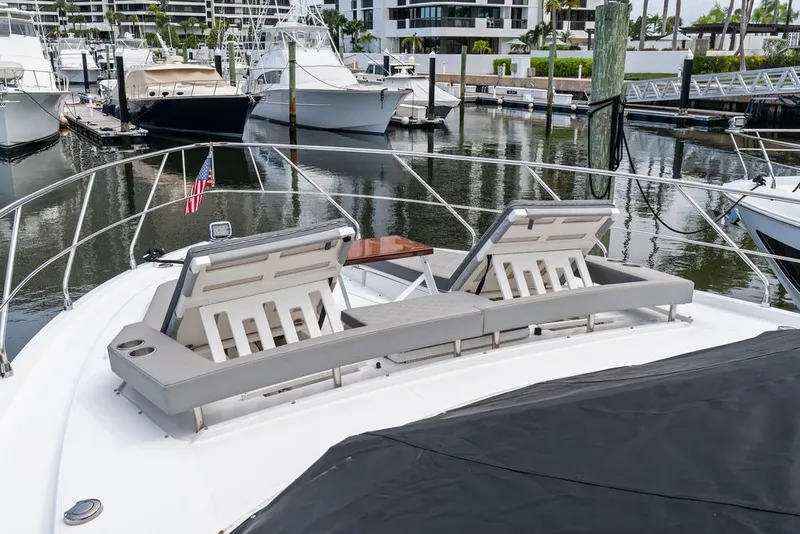 Slide: The Image of Luxurious 2022 Cruisers Yachts 54 Cantius with sun loungers docked at marina. - 25
