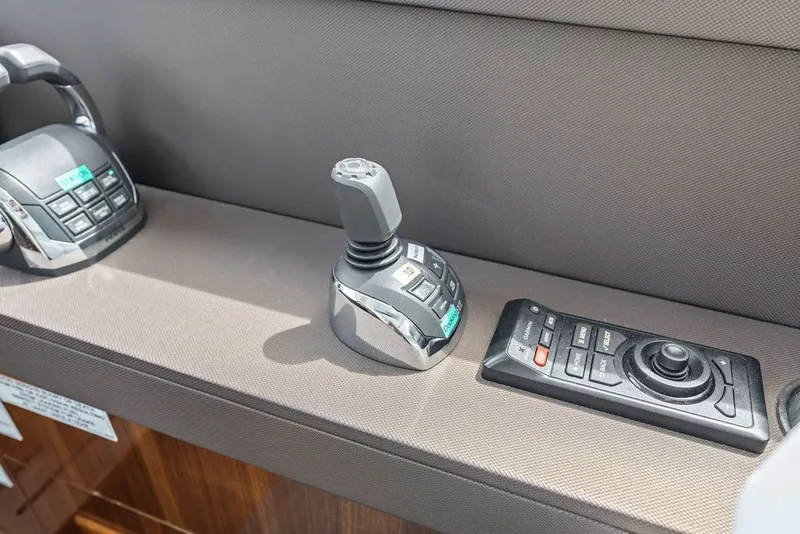 Slide: The Image of Control panel of 2022 Cruisers Yachts 54 Cantius with joystick and remote. - 52