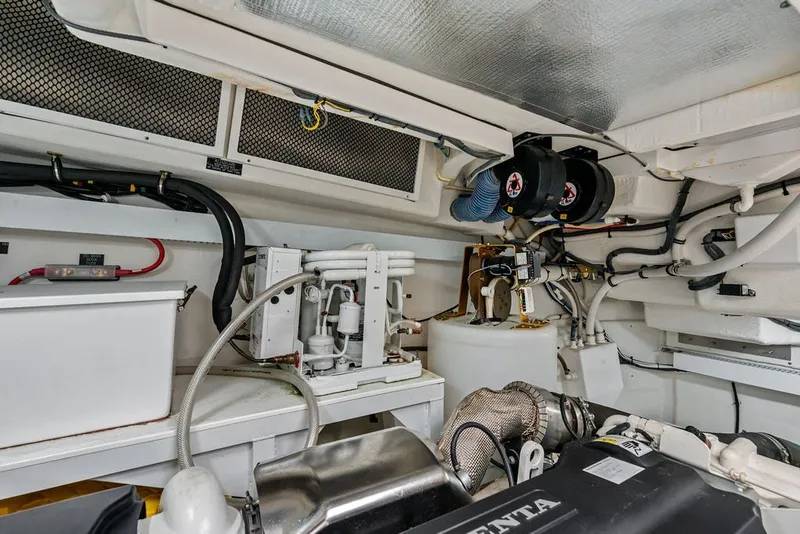 Slide: The Image of Engine room of 2022 Cruisers Yachts 54 Cantius, showcasing mechanical components and systems. - 81