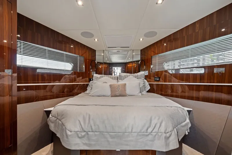 Slide: The Image of Luxurious bedroom interior of 2022 Cruisers Yachts 54 Cantius with elegant wood paneling. - 63