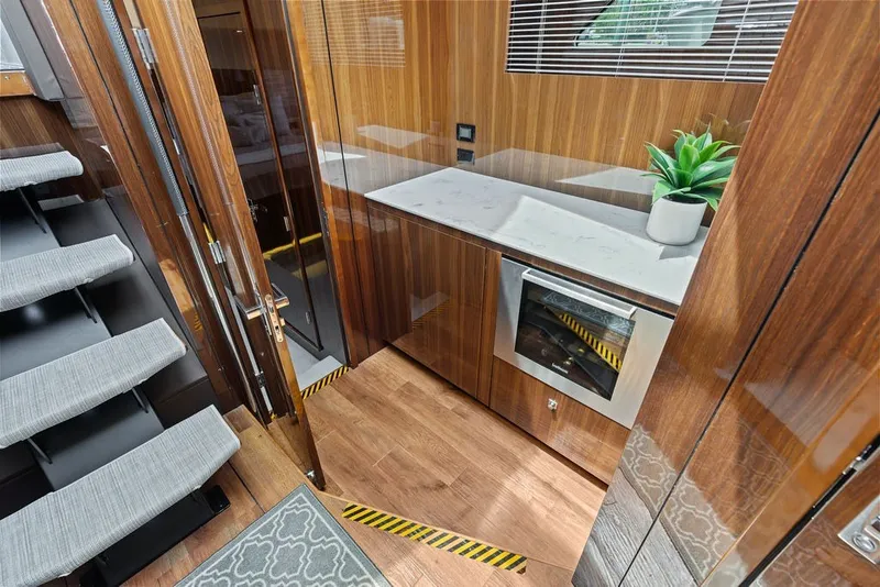 Slide: The Image of Luxurious 2022 Cruisers Yachts 54 Cantius interior with modern kitchen and elegant wood finishes. - 53