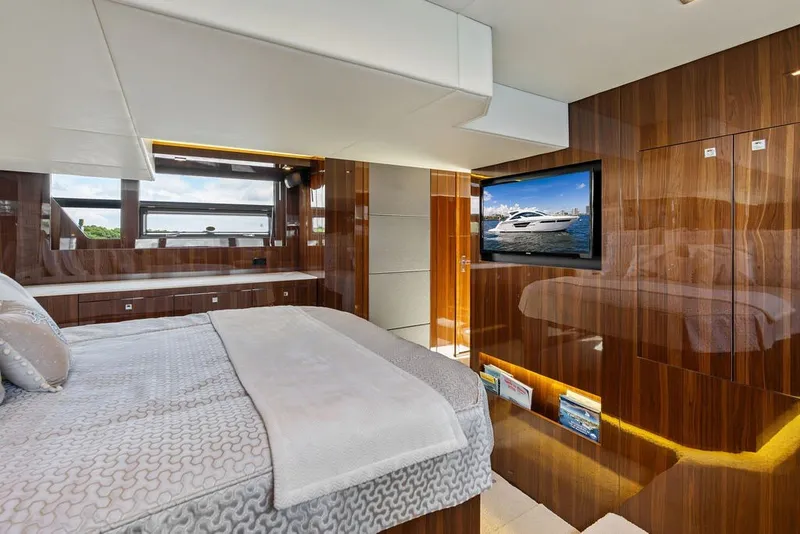 Slide: The Image of Luxurious 2022 Cruisers Yachts 54 Cantius bedroom with elegant wood paneling and modern amenities. - 57