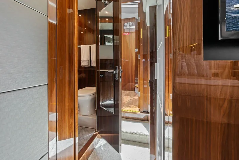Slide: The Image of Luxurious bathroom interior on 2022 Cruisers Yachts 54 Cantius, featuring sleek wood finishes. - 61