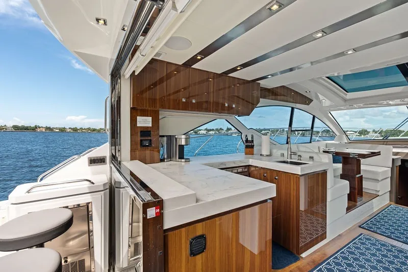 Slide: The Image of Luxurious interior of 2022 Cruisers Yachts 54 Cantius with modern kitchen and ocean view. - 38
