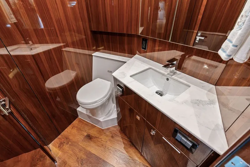 Slide: The Image of Luxurious bathroom in 2022 Cruisers Yachts 54 Cantius with wood finish and modern fixtures. - 68