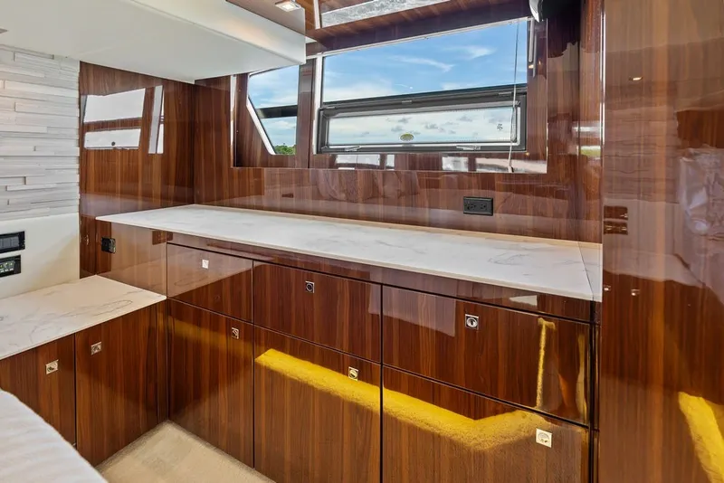 Slide: The Image of Luxurious interior of 2022 Cruisers Yachts 54 Cantius with sleek wood cabinetry and modern design. - 59