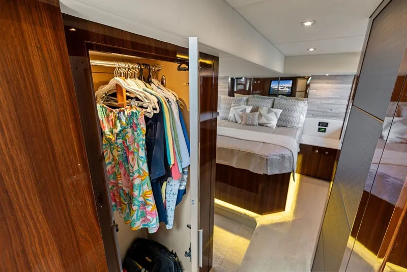 Slide: The Image of Luxurious 2022 Cruisers Yachts 54 Cantius interior with open closet and elegant bedroom. - 55